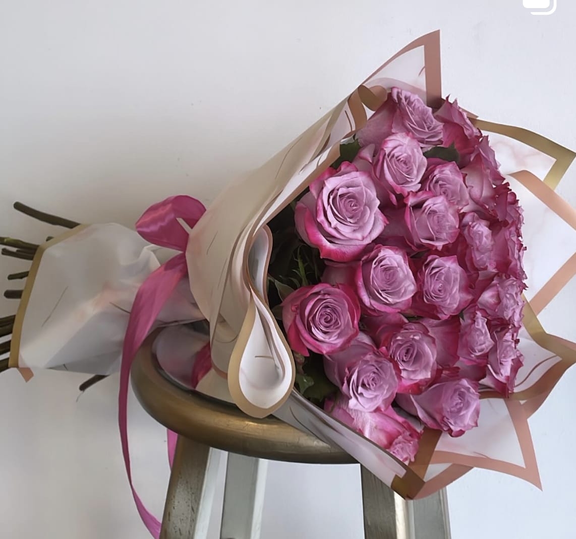 Purple Rose Bouquet -  Elevate your gift-giving with a stunning arrangement of 25 luxurious purple roses elegantly wrapped in a bouquet. Make a lasting impression with this exquisite floral display that is sure to delight any recipient.