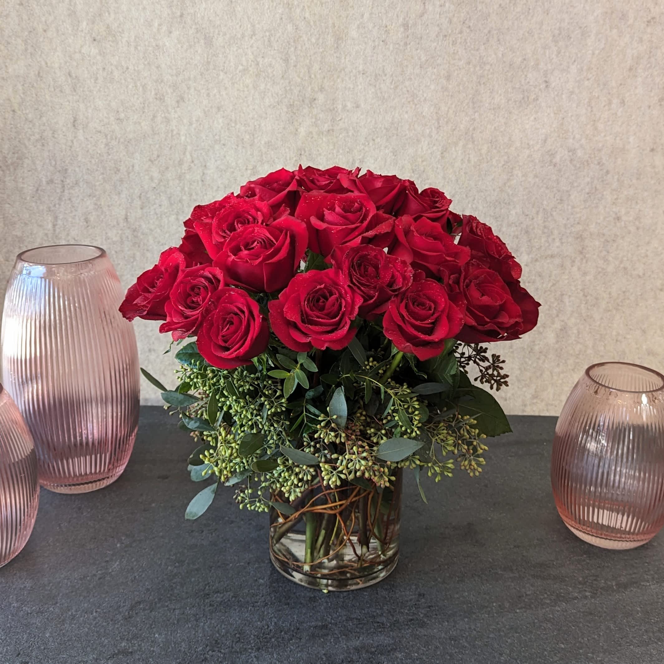 Rose Love - Our Standard Rose Love arrangement features two dozen rich, red roses artfully arranged in a clear glass cylinder. Sleek and stylish, These premium Ecuadorian-sourced blooms speak volumes of love without saying a word.  The photo is shown in the Premium version. Also available in lavender, orange, peach, pink, purple, white, or yellow. Please note your preferred color in the special instructions.   