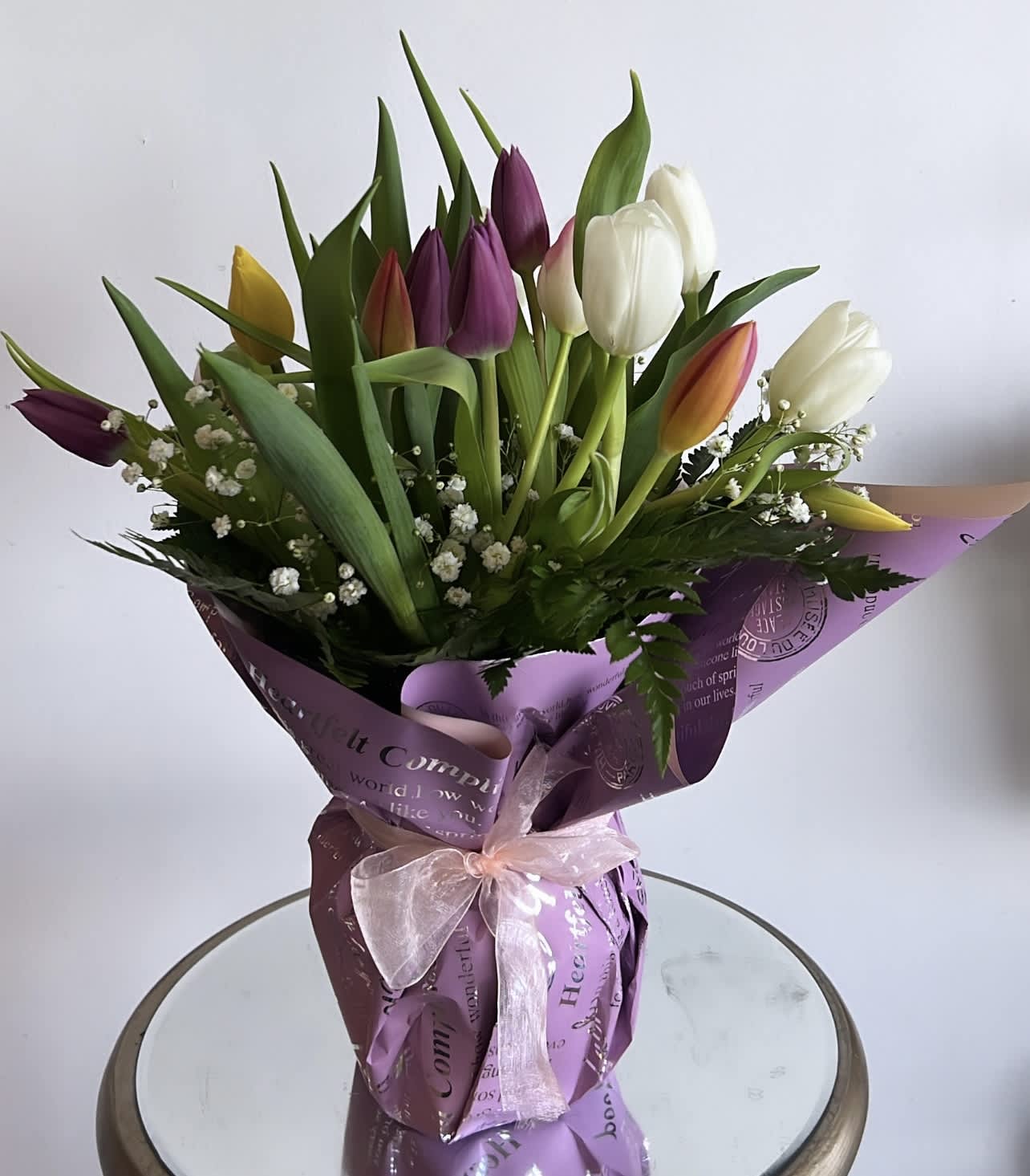 Timeless Tulips  - Cheerful tulips are nature’s way of saying, Spring is here! Our timeless bouquet is filled with these feel-good blooms in a bunch of bright colors. Gathered in a clear glass vase finished with a raffia bow, it’s an everyday gift of instant happiness.