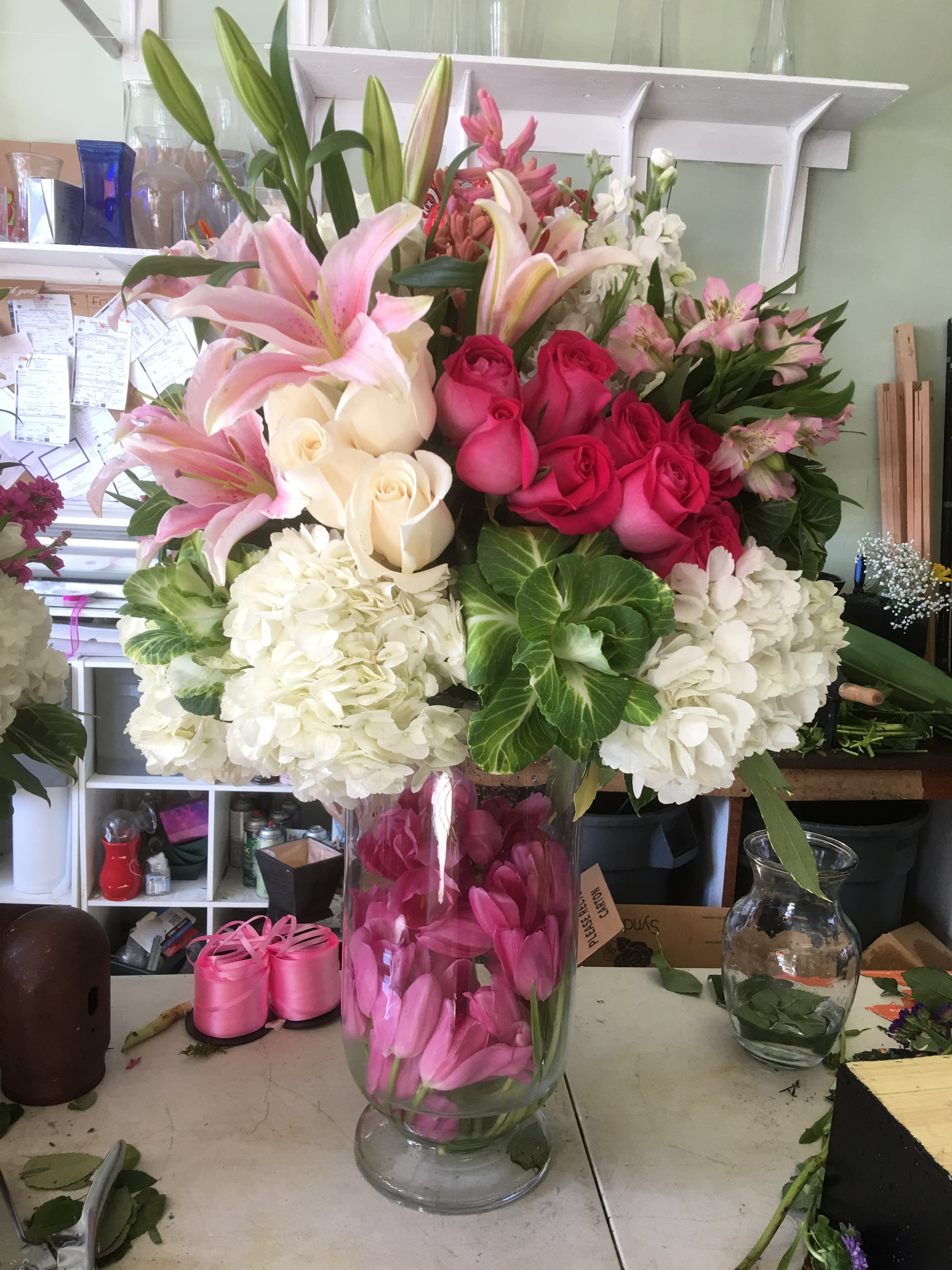 Pink Paradise - Roses, hydrangeas, lilies in a tall elegant vase with bunches of wild tulips inside