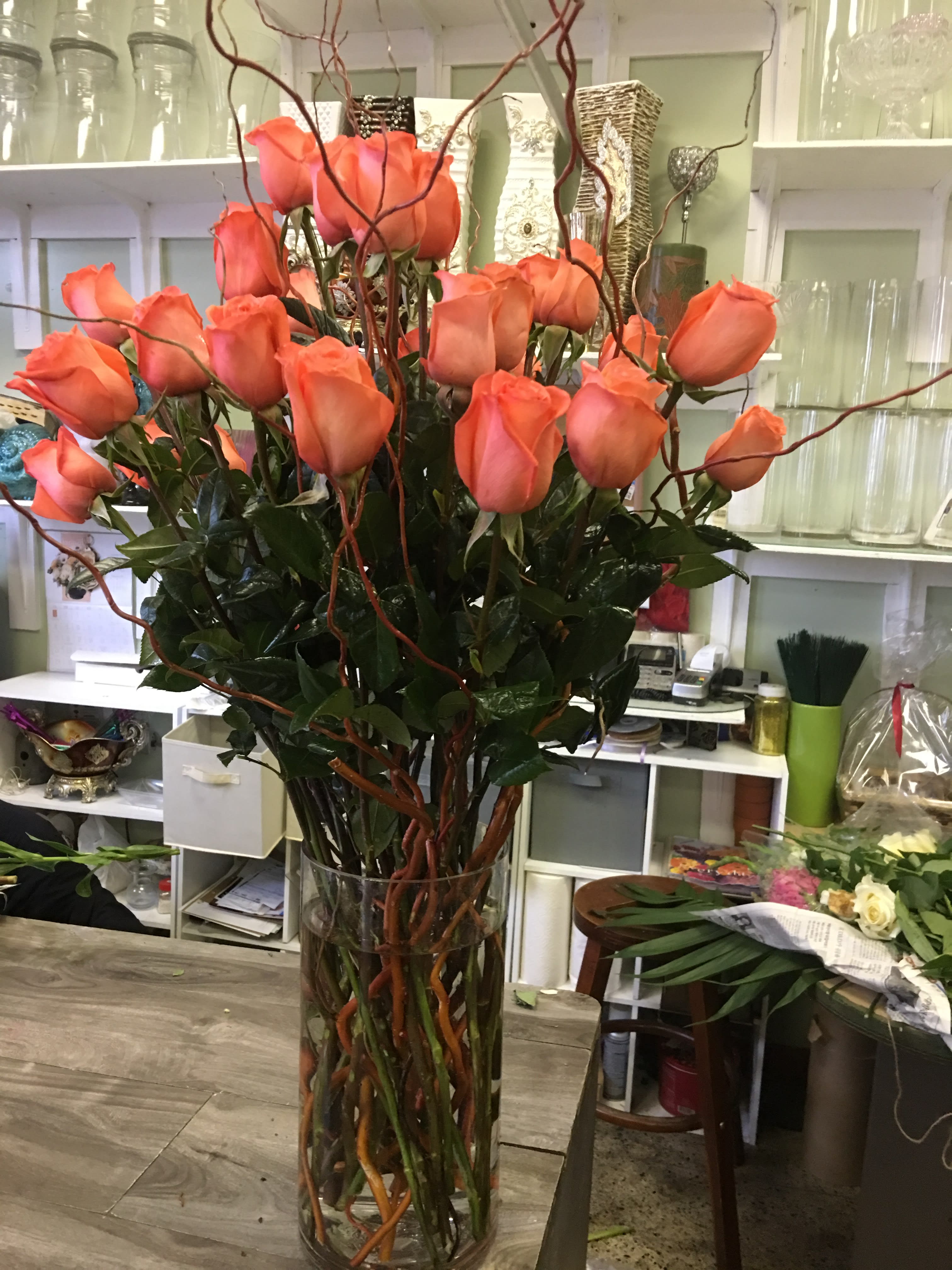 Pink Salmon Roses - 24 salmon colored roses with stems of beautiful curly willow in a tall elegant glass vase