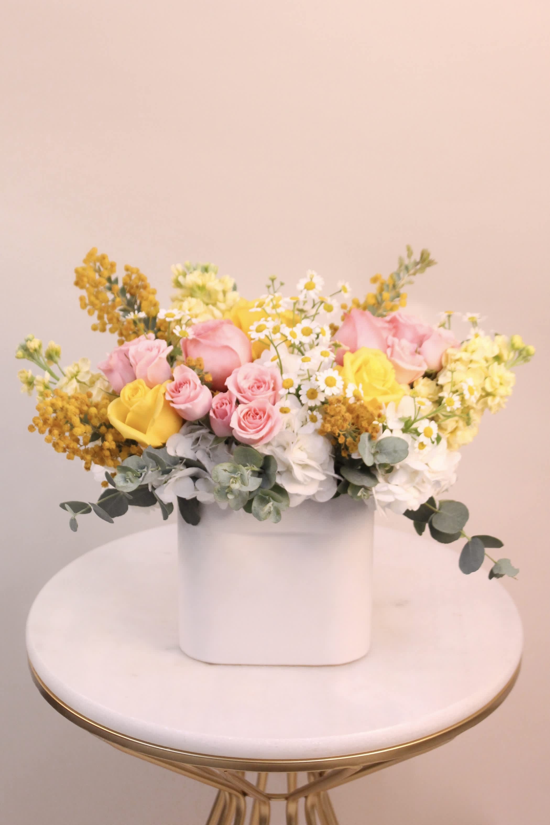 Citrus Blossom - A fresh mix of flowers in an oval ceramic vase. Flowers may include garden roses, hydrangeas, majolica spray roses, chamomile, stock, mimosa and eucalyptus.  Vase dimension: 6&quot; W x 2.6&quot; L x 5.9&quot; H 