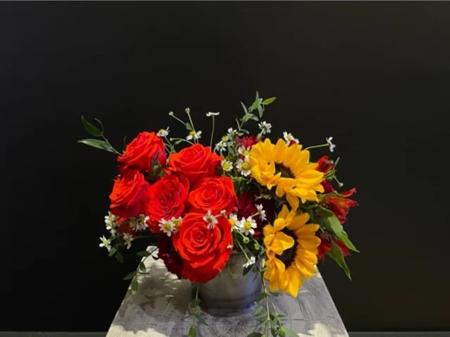 Colorado Girl - Colorado Girl is an arrangement that features the native sunflower and red roses. It is inspired by a classic summer day in Colorado, and not just for the girls, but especially for them. 