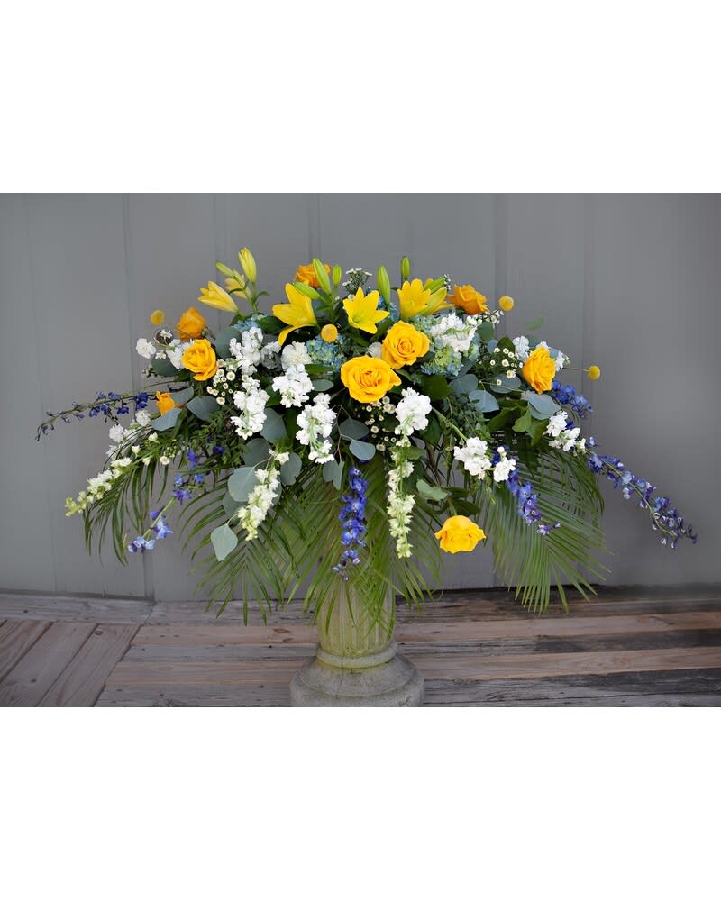 Gentle Reflections Casket Spray - The vibrant colors in the casket spray pay tribute to the vibrant life of a departed loved one.  Though the yellow stands out,  it is a gentle reflection of a life well-lived, mixed with complimentary colors ready to be tastefully displayed in a tribute. 