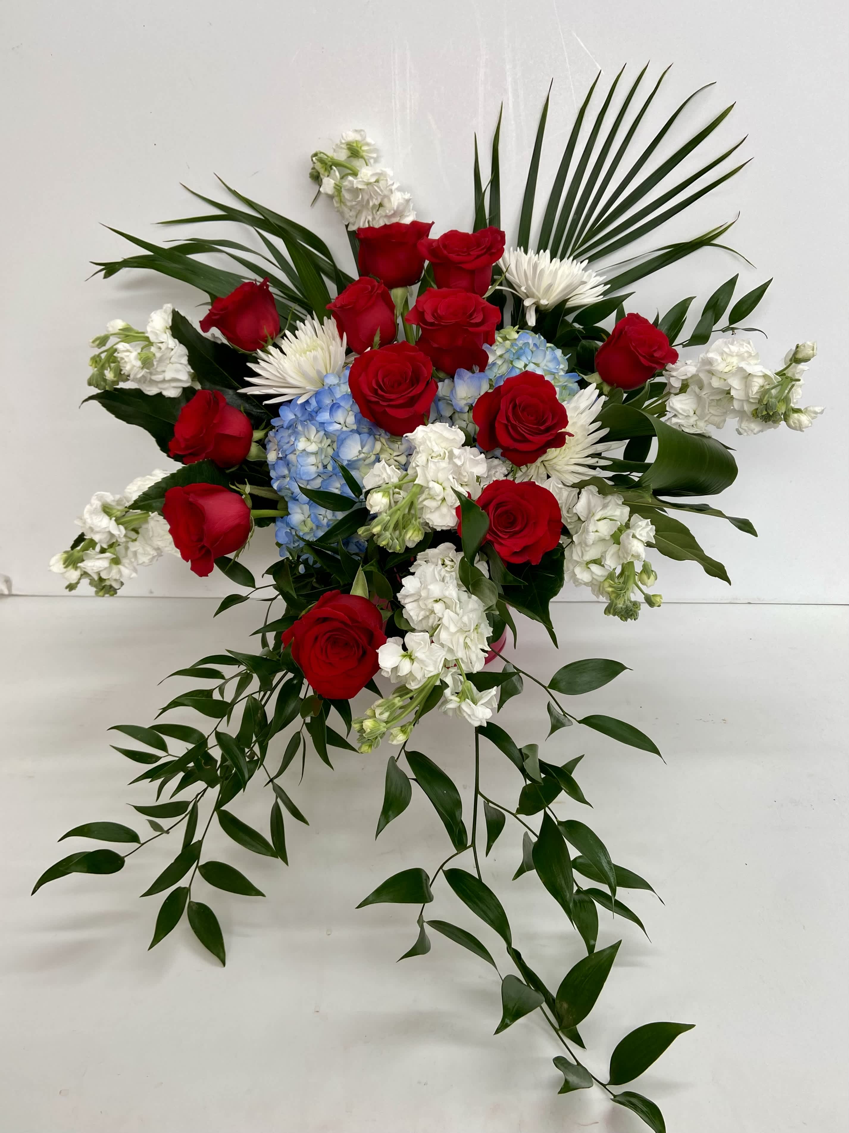 Sacred  Heart Bouquet - Standing proud and patriotic, this dazzling  display made of graceful flowers. Uniquely beautiful, it's a lovely way to honor a great loss. 