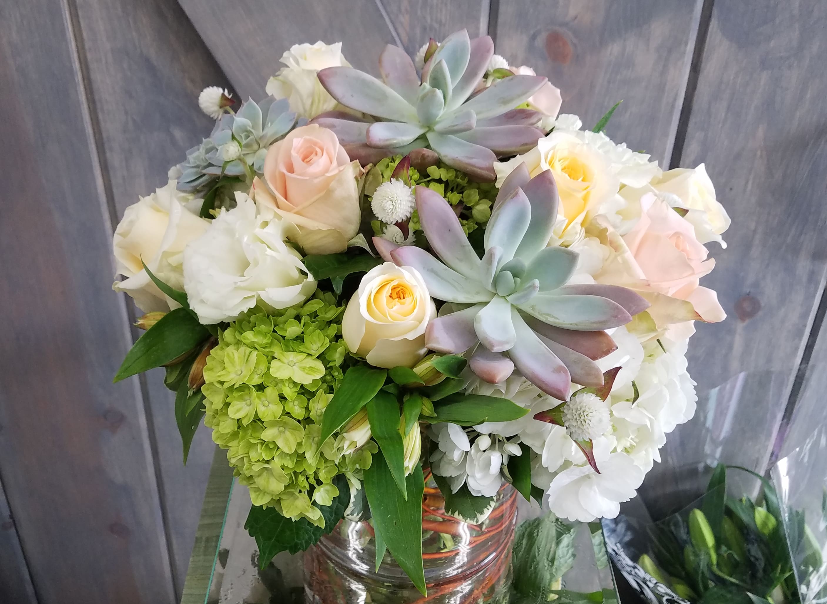 Sorbet - Sorbet is a dreamy design filled with White Hydrangea, Mini Green Hydrangea, Creme Dela Creme Roses, Tiffany Roses, White Lisianthus, Succulents, and Alstromeria,