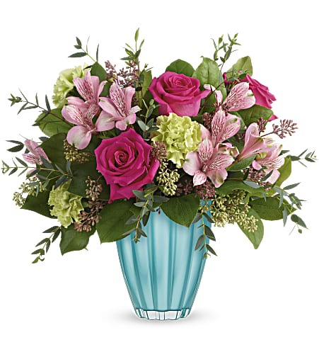 Teleflora's Enchanted Spring Bouquet Teleflora's Enchanted Spring Bouquet - Spring has sprung! Capture the enchantment of the new season with this cheerful rose bouquet, perfectly presented in a gorgeous European glass vase in the most awe-inspiring shade of aqua. This enchanting bouquet includes hot pink roses, pink alstroemeria, green carnations, parvifolia eucalyptus, lemon leaf, and seeded eucalyptus. Delivered in Teleflora's Enchanted Spring vase. Approximately 16 1/2" W x 15 1/2" H