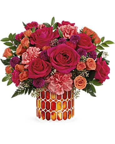 Teleflora's Sunset Blooms Bouquet Teleflora's Sunset Blooms Bouquet - As mesmerizing as a summer sunset, this majestic mix of colorful roses in a magnificent mosaic glass vase is a gift they'll treasure. This arrangement includes hot pink roses, orange spray roses, orange carnations, purple button spray chrysanthemums, miniature hot pink carnations, seeded eucalyptus, leatherleaf fern and huckleberry. Delivered in Teleflora's Autumn Radiance Mosaic vase.