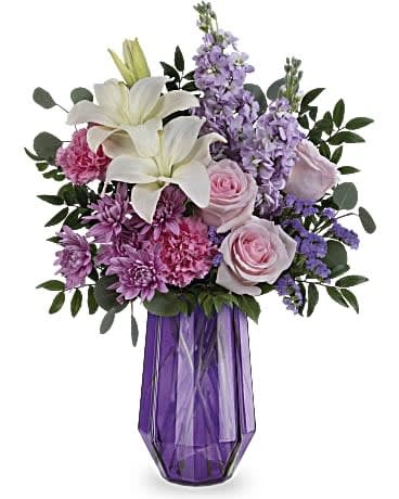 Teleflora's Lavender Whimsy Bouquet Teleflora's Lavender Whimsy Bouquet - Wish her a Mother's Day of wonder and whimsy with Teleflora's Lavender Whimsy Bouquet featuring a breathtaking rose and lily bouquet in this stunning geometric glass vase.