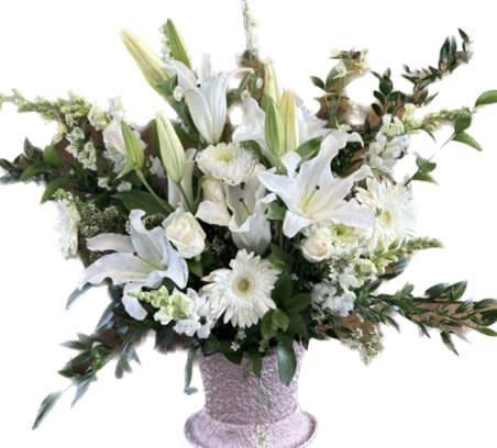 Bright Star Bright Star - A wispy white and green basket featuring silver dollar eucalyptus and white iris. This arrangement smells lovely and is suitable for any type of ceremony.