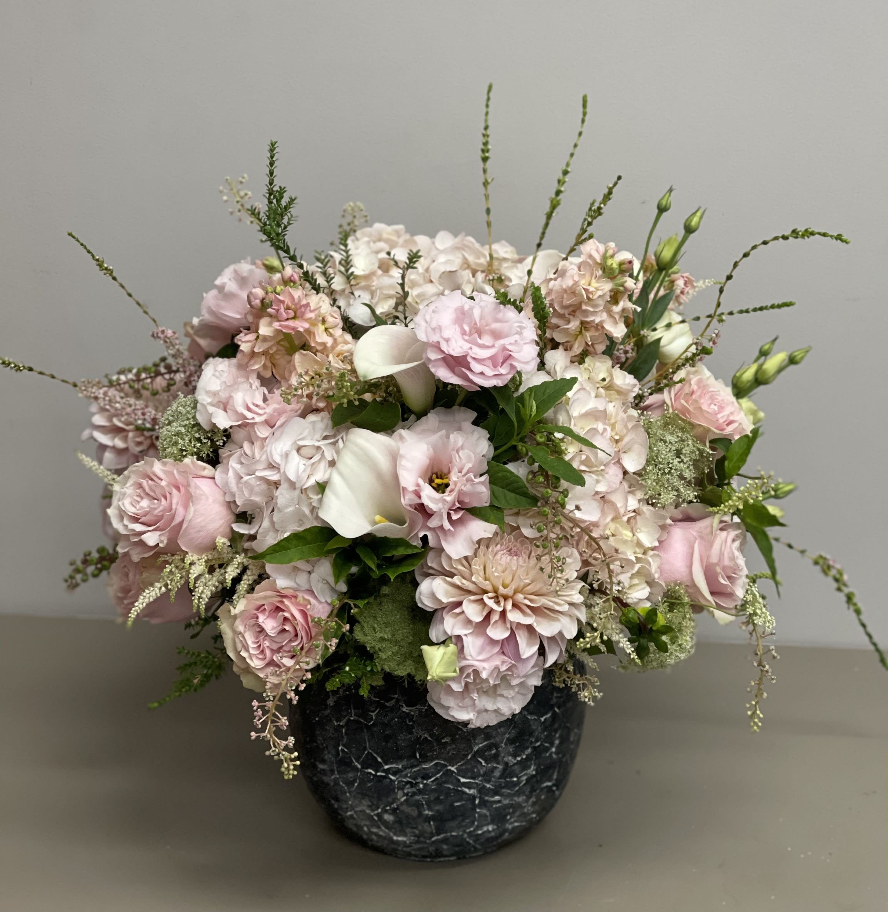 European Garden - Beautiful combination of light pink Hydrangeas, Res, Lisianthus, Dahlia and other seasonal flowers and greens in a ceramic container.  **container might vary due to availability**