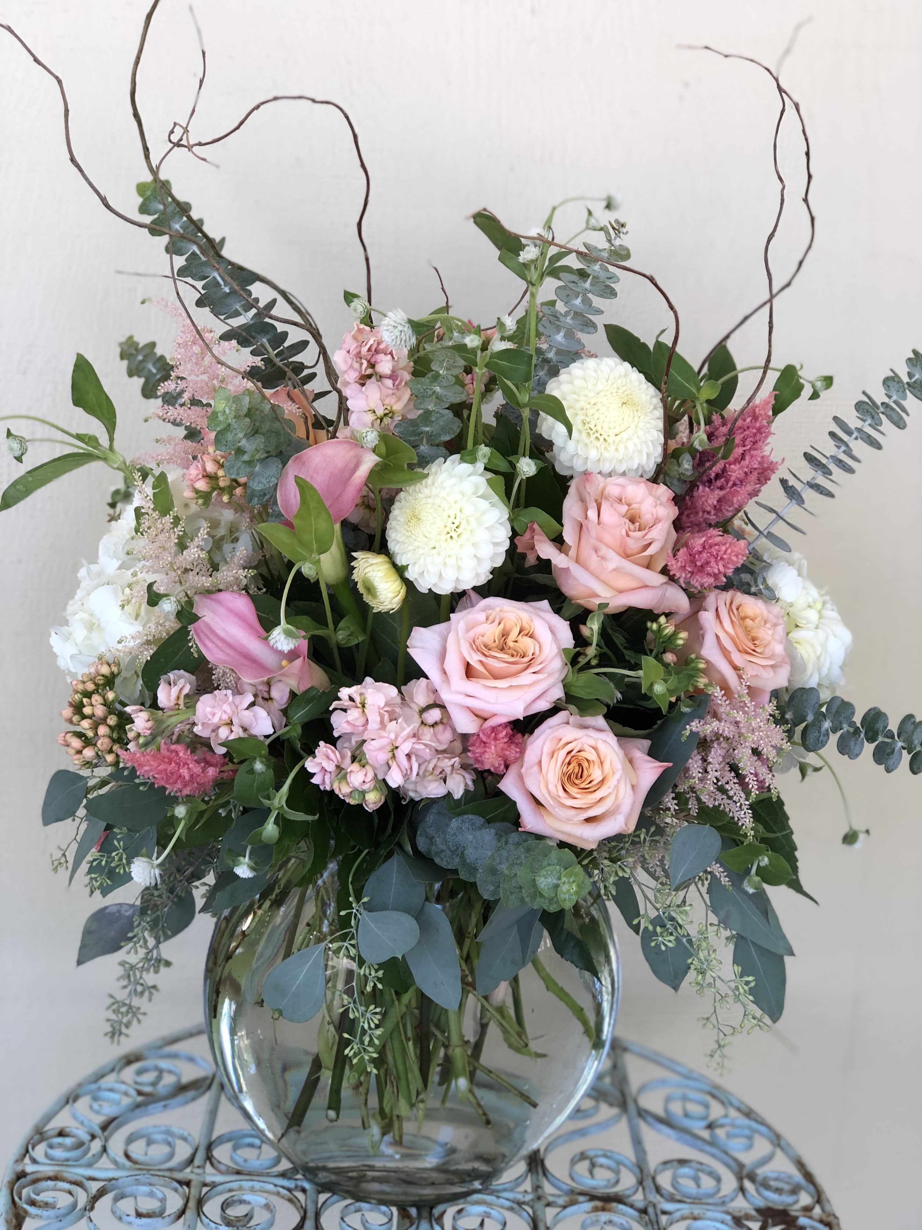Envy - A beautiful combination of Roses, Dahlia, Hydrangeas, Calla, Astilbe and other seasonal flowers &amp; greens in a tall glass vase. Floral Arrangement subject to change based on seasonal availability. Containers subject to change based on availability. However we will create something very similar to the photo. 
