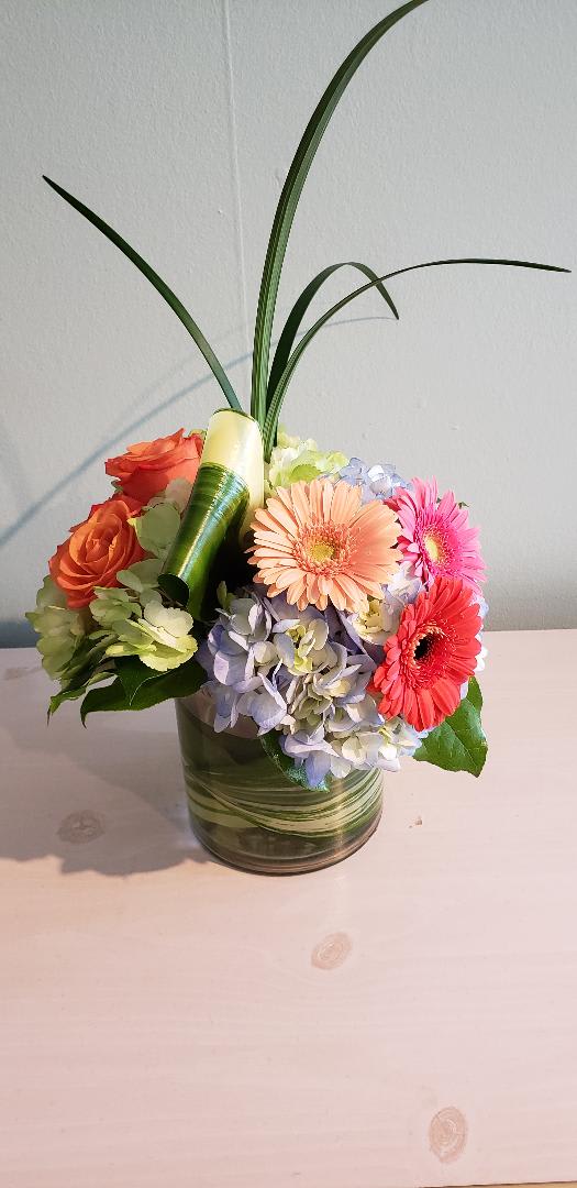 Summer Lovin Summer Lovin - This beautiful array of bright colorful gerber daises; hydrangeas; and roses will warm your heart like summertime fun!