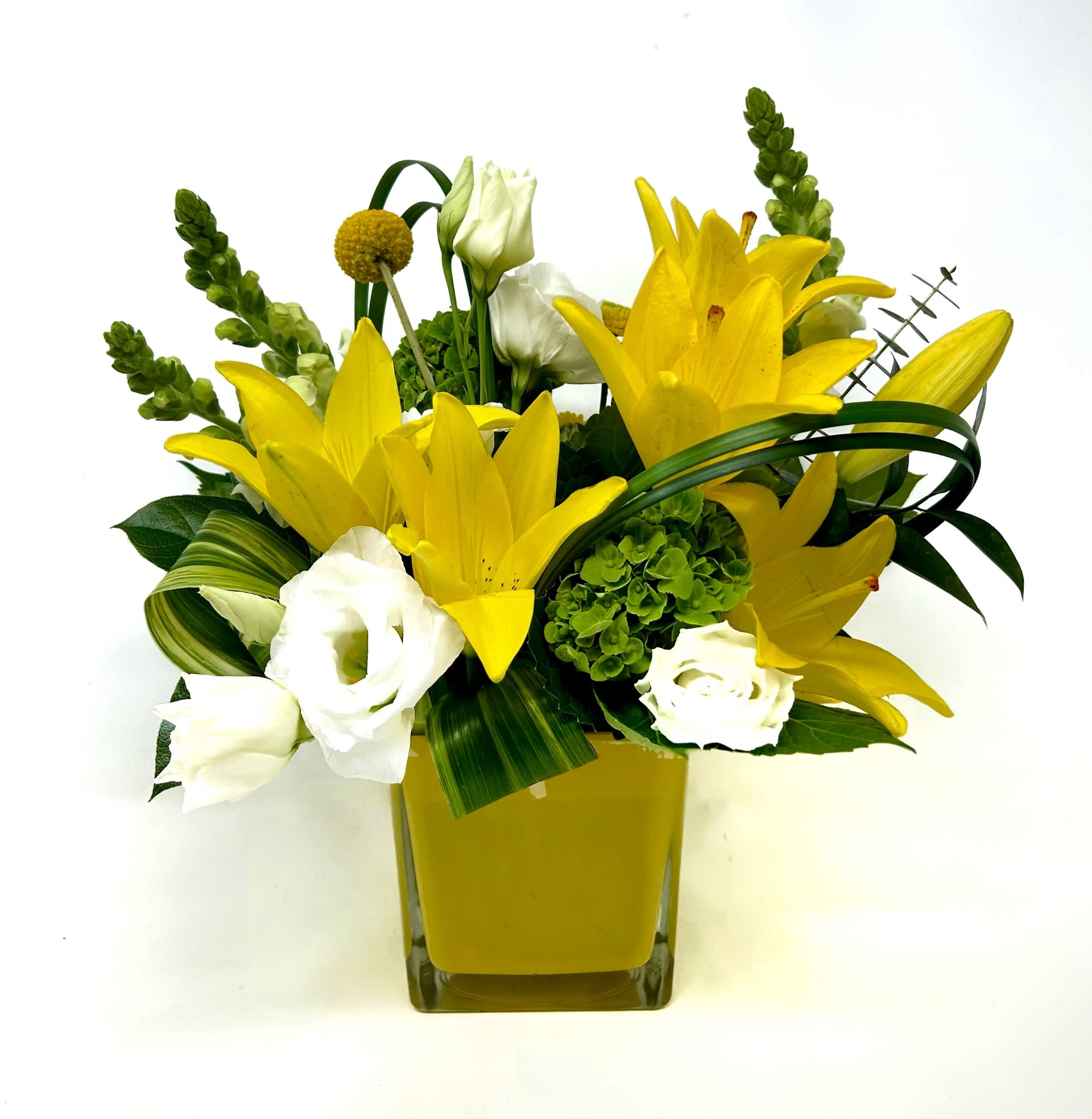 Limoncello  - Bright yellow asiatic lilies and other season blooms in a yellow glass cube.