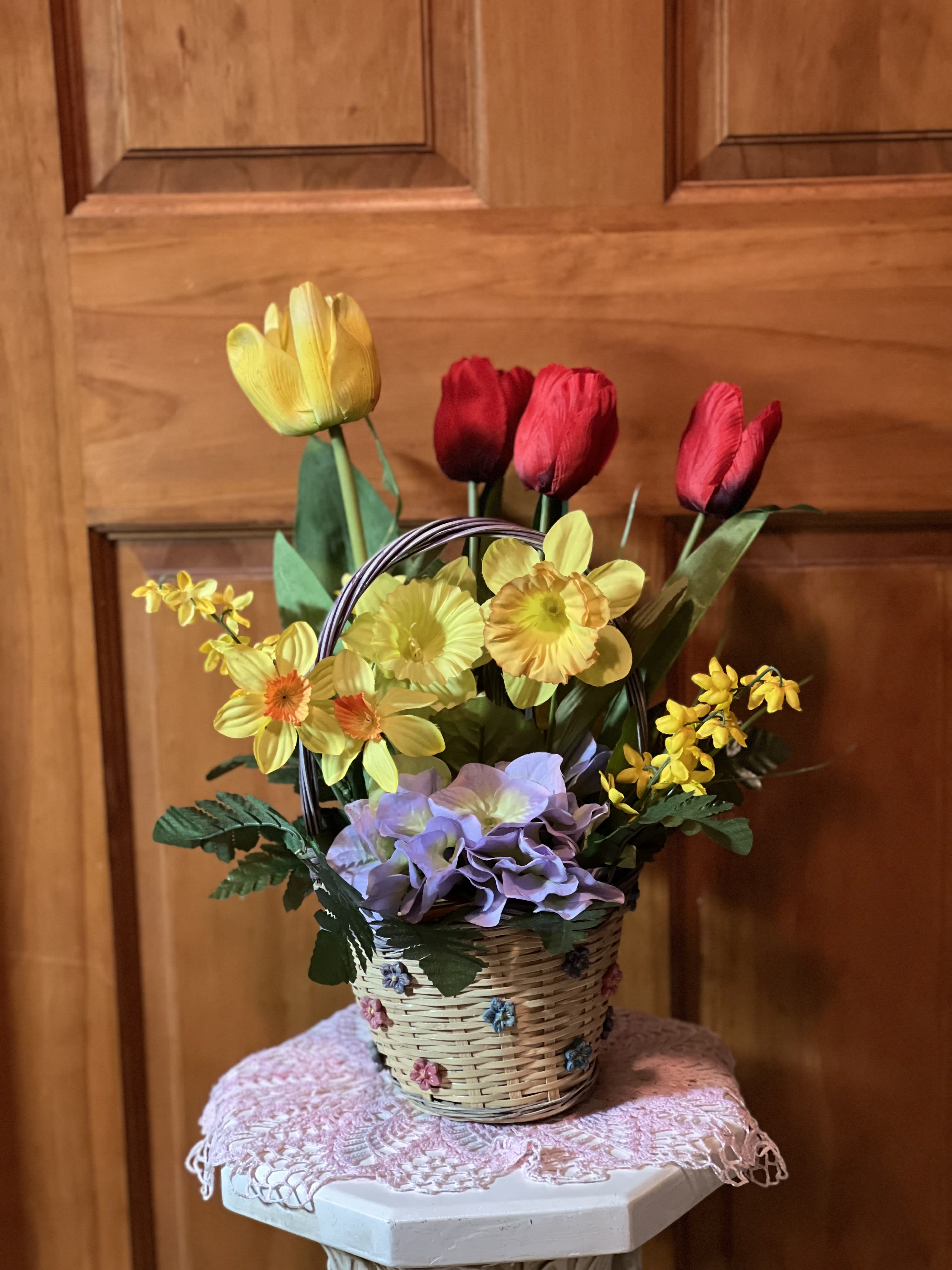Permanent Spring's Blooms  - A keepsake arrangement to be proudly brought out every Spring. Wonderful yellow and red lifelike silk tulips. Silk soft lavender hydrangea and cute little daffodils round out this design. Sure to become a treasured gift. Cuddled into a whitewash basket trimmed with dainty flowers. Approximate size of basket: 5&quot; X 4&quot; X 11&quot; tall.  Silk Flowers rise above the basket to look like they are growing. 