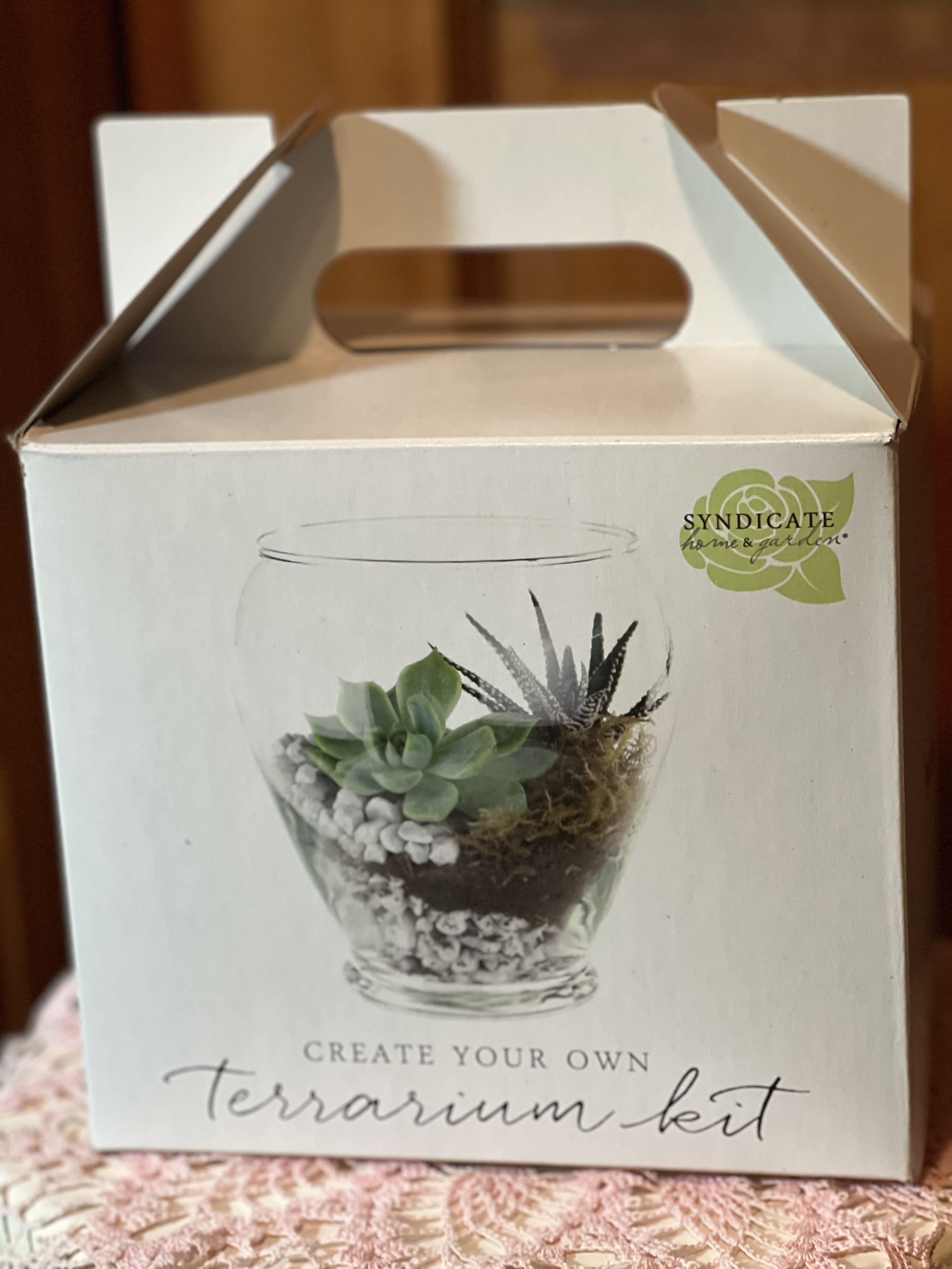 Terrarium Kit - This giftable kit has all the makings of a lush, living terrarium. Just add your favorite plant and cultivate an indoor garden that will flourish throughout the year. Perfect for adding a slice of nature to any desktop or coffee table. Keep your terrarium thriving with simple assembly and minimal maintenance. Charming hand-illustrated packaging makes this a lovely gift. We recommend pairing with our Terrarium Tool Kit to create the perfect design! Includes modern glass vessel Includes drainage stone, soil and moss Use stones as base, then layer soil and moss Crafted from recycled material Packaged in a box with a convenient handle for easy gifting Product Dimensions  Height: 5.75 in Length: 7.5 in Width: 5.75 in Weight: 2.5 lbs