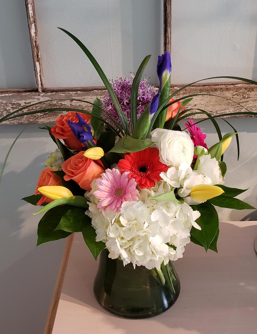 Glorious Spring - A gorgeous array  of all imported spring blooms arranged in a large glass gathering vase. Sure to impress.