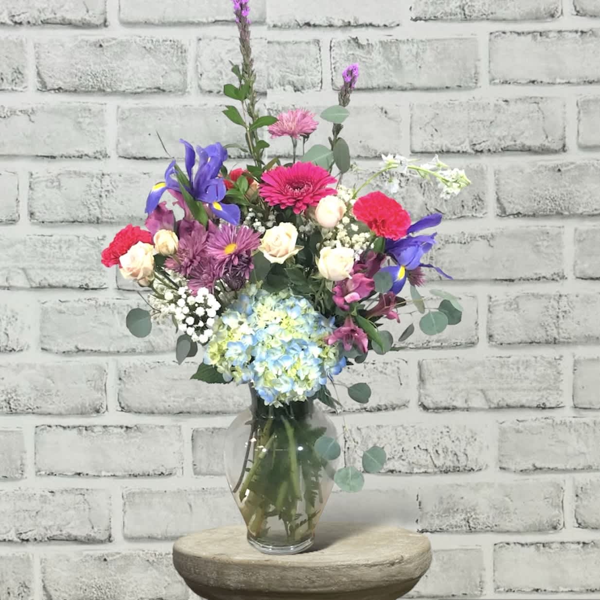 Mom's Endless Love FG222 - This traditional design in a vase has beautiful flowers in colors of spring.  It include both roses and spray roses.    Approximately 27&quot; H x 18&quot; W.