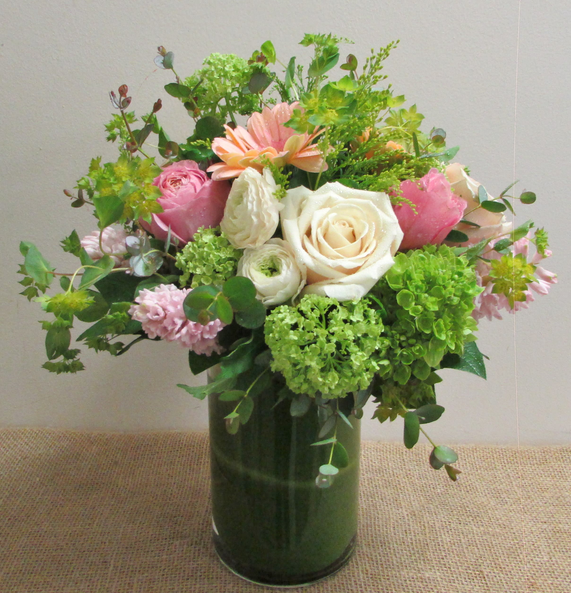 Beauty and Love - A beautiful arrangement of muted colors for a lovely and classy spring arrangement. Arranged in a lower glass vase 