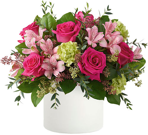 Mother's Garden - Mother's Garden&quot; captures the essence of a tranquil oasis blooming with love. Nestled within a sleek white cylinder vase, vibrant hot pink roses, delicate pink alstroemeria, and verdant green carnations intertwine with lush greens. This arrangement is a testament to the nurturing spirit of mothers, exuding elegance and tenderness. A harmonious blend of colours and textures, &quot;Mother's Garden&quot; is a heartfelt tribute, perfect for honouring the remarkable mothers in our lives.