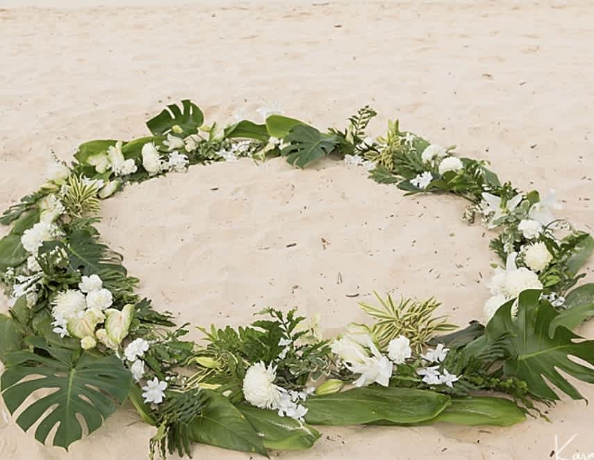 Engagement circle (proposal flowers) - Create the Perfect Moment with our Engagement Flower Circle on the Beach! Are you ready to pop the question and create a memory that will last a lifetime? Look no further than our enchanting Engagement Flower Circle on the Beach. Imagine walking hand in hand with your loved one along the pristine shores of Hawaii, surrounded by a breathtaking circle of fresh flowers. Our skilled team will meticulously design and create a stunning flower circle tailored to your preferences, ensuring that every detail is just right for your special moment. Whether you envision a romantic sunset proposal or a sunrise surprise, our custom package is designed to meet your exact needs. We will work closely with you to select the perfect flowers, colors, and arrangement to create a truly magical setting. Our commitment to excellence extends