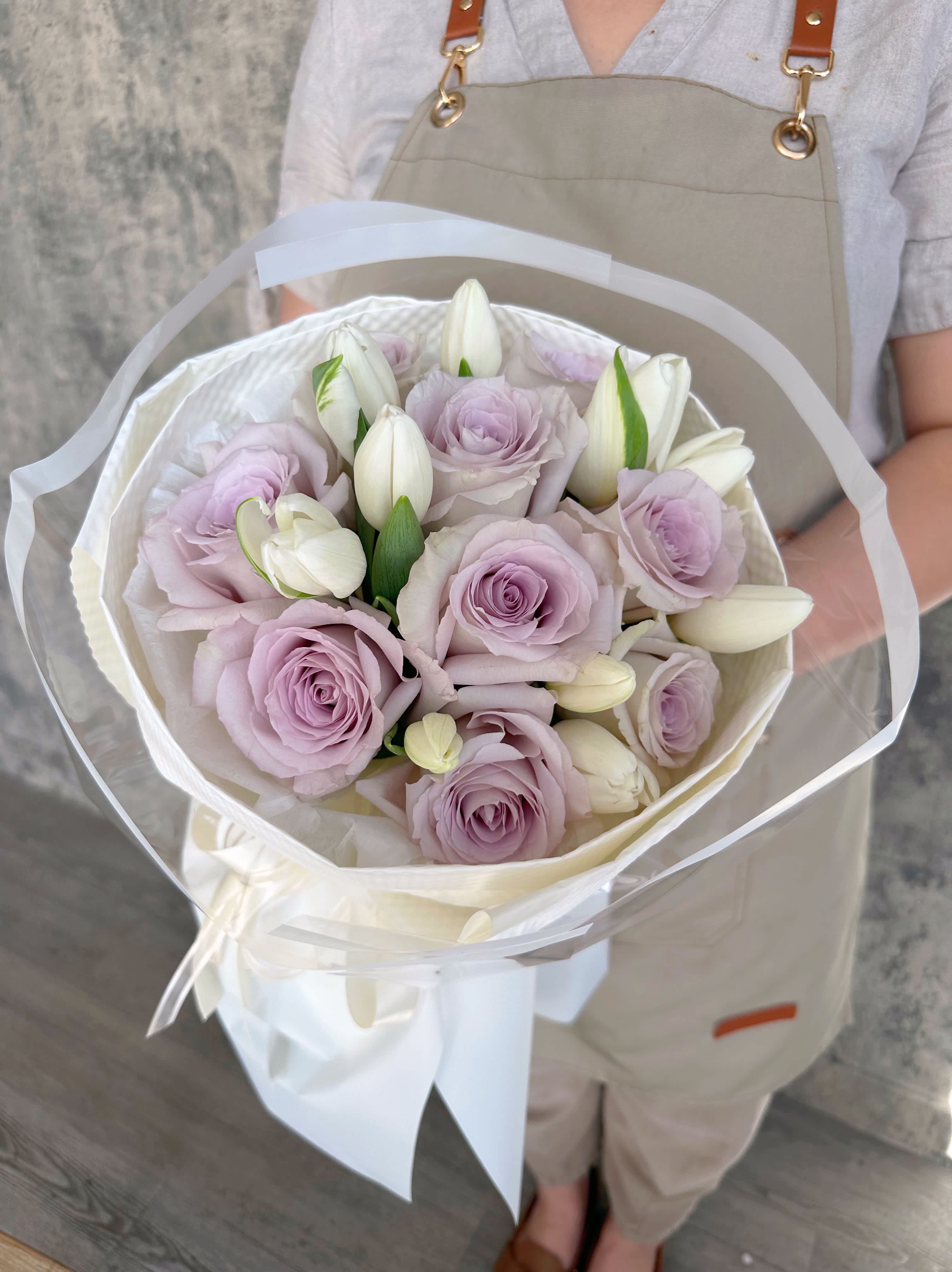 Thank you Mom - 9 Andrea long stem roses in dusty lavender color mix with pure white tulips make so gently cute bouquet wrap. Size 11”x 17”.  Deluxe will be 1 &amp;1/2 Dz long stem roses mix with tulips.
