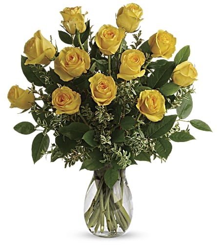 Yellow Roses -  Radiant Sunshine in a Bouquet of Yellow Roses  This gorgeous floral arrangement is a radiant display of sunshine and happiness, featuring a dozen stunning yellow roses elegantly arranged in a vase with lush greens and delicate filler flowers. The perfect choice to express joy, friendship, or love, this bouquet is a beautiful gift that is sure to brighten anyone's day.   The Roses:     **Yellow Roses:** Symbolizing friendship, joy, and new beginnings, the yellow roses in this arrangement exude a warm and inviting energy. With their vibrant yellow petals and enchanting fragrance, these roses are a classic choice that never fails to bring a smile to someone's face.   The Greenery and Filler Flowers:    **Lush Greens:** The carefully selected greenery provides a lush backdrop for the yellow roses, adding depth and texture to the arrangement. From graceful foliage to sprigs of delicate leaves, these greens enhance the natural beauty of the roses, creating a visually captivating display.   **Filler Flowers:** Delicate filler flowers, such as baby's breath or wax flowers, are interspersed among the roses and greenery to add a touch of finesse and elegance. These dainty blooms create an exquisite balance in the bouquet, enhancing the overall visual appeal.  The Vase:  The vase is carefully chosen to accentuate the beauty of the roses, displaying them in all their glory. Whether it's a clear glass vase that highlights the vibrant yellow hue or a complementary colored vase that adds a touch of sophistication, the vase serves as a lovely frame for this bouquet of sunshine.  This bouquet of 12 yellow roses is a delightful expression of happiness and warmth, making it a perfect gift for birthdays, anniversaries, or just to uplift someone's spirits. Each rose is hand-selected and expertly arranged with care, ensuring a stunning presentation that will leave a lasting impression. Shower your loved ones or yourself with the beauty and joy of these yellow roses, and let the magnificence of nature's golden hues brighten your day. 