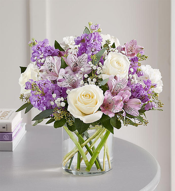 Lovely Lavender - Lovely memories are made with thoughtful gifts for the ones we care about. Our charming bouquet is loosely gathered with a medley of lavender &amp; white blooms. Hand-designed inside a clear cylinder vase with cascading greenery all around, it’s a wonderful way to express the sentiments you have inside your heart.
