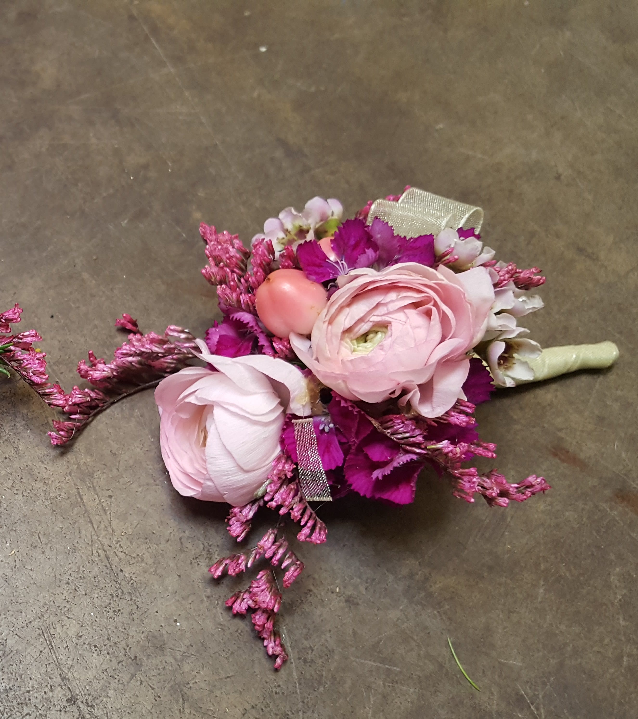 Berry Sweet Boutonniere Berry Sweet Boutonniere - Select this Berry Sweet Boutonniere with pink ranunculus and berry accents. All Prom Flowers are available in colors pictured or a custom selection. Choose your flower colors, ribbon color and any add ons. For questions call a friendly sales representative at STRELITZIA FLOWER CO.