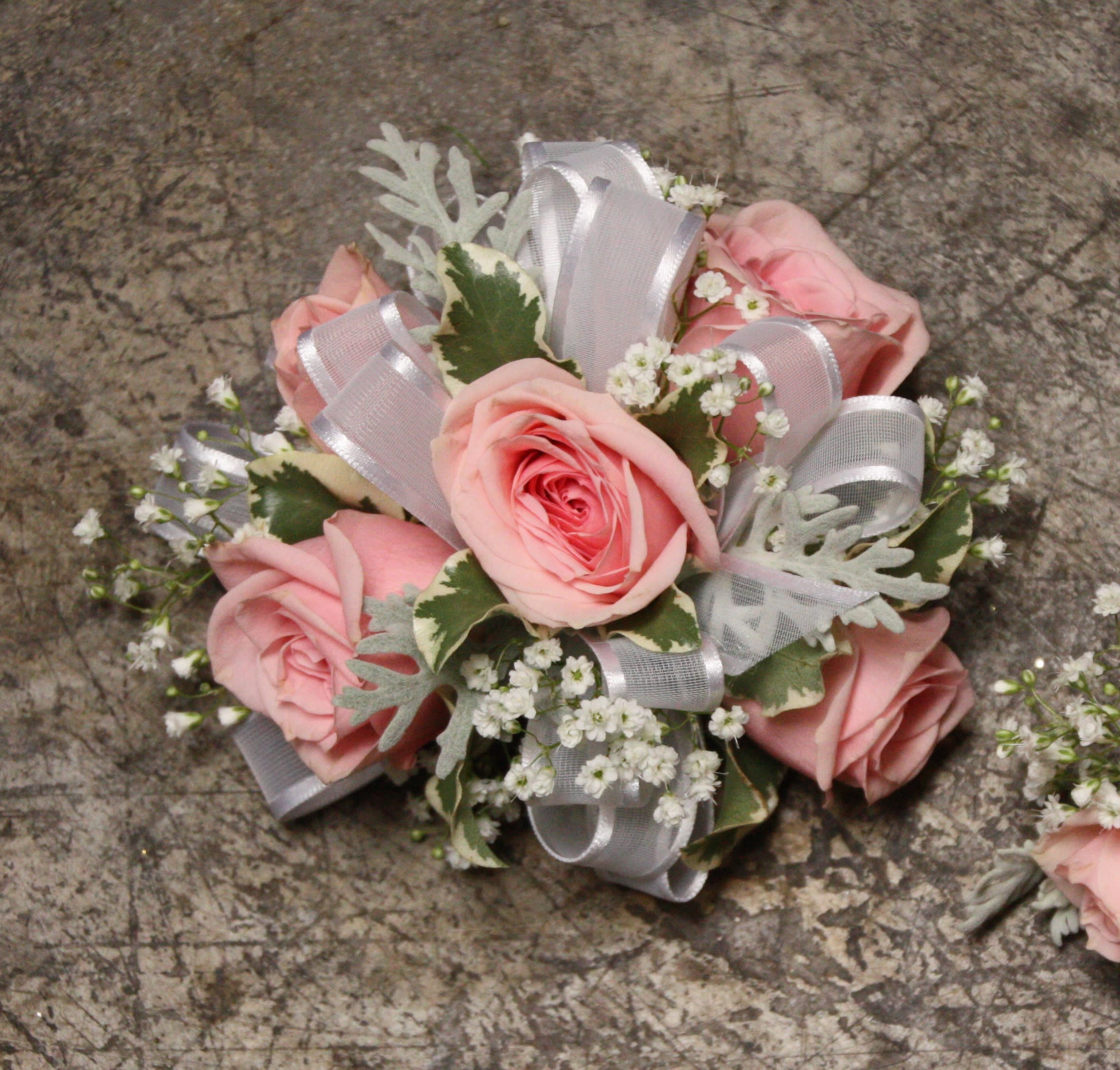 Cotton Candy Wristlet Cotton Candy Wristlet - Select this corsage consisting of 5 pale pink spray roses with babies breath and sheer white ribbon. ALL PROM FLOWERS ARE AVAILABLE IN COLORS PICTURED OR A CUSTOM SELECTION. CHOOSE YOUR FLOWER COLORS, RIBBON COLOR AND ANY ADD ONS. FOR QUESTIONS CALL A FRIENDLY SALES REPRESENTATIVE AT STRELITZIA FLOWER CO.