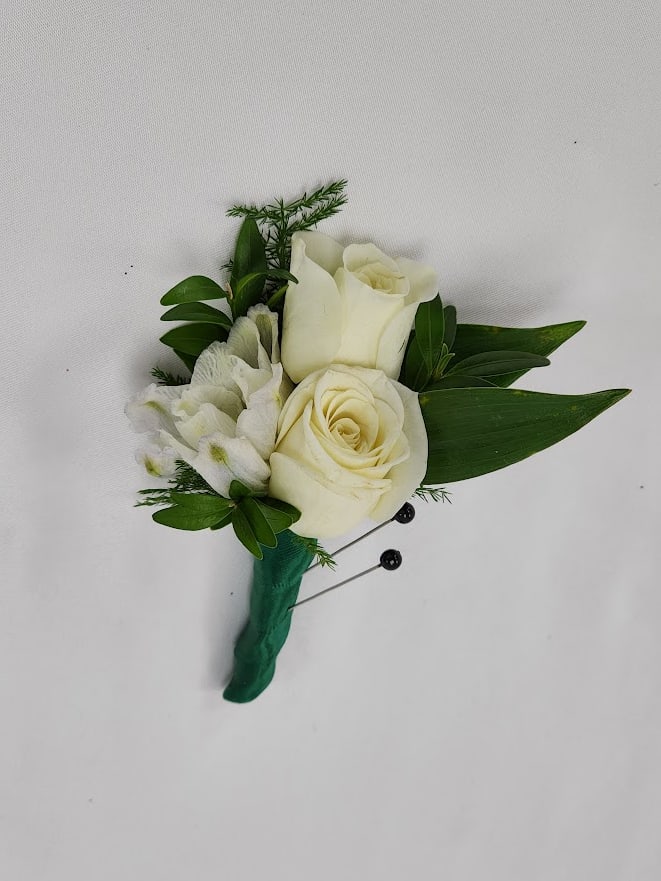 Green Envy Boutonniere Green Envy Boutonniere - Select this white spray rose and white bella donna boutonniere wrapped in emerald green ribbon.Each boutonniere comes with two metal pins to pin on a jacket lapel or shirt. Exact flowers may vary.