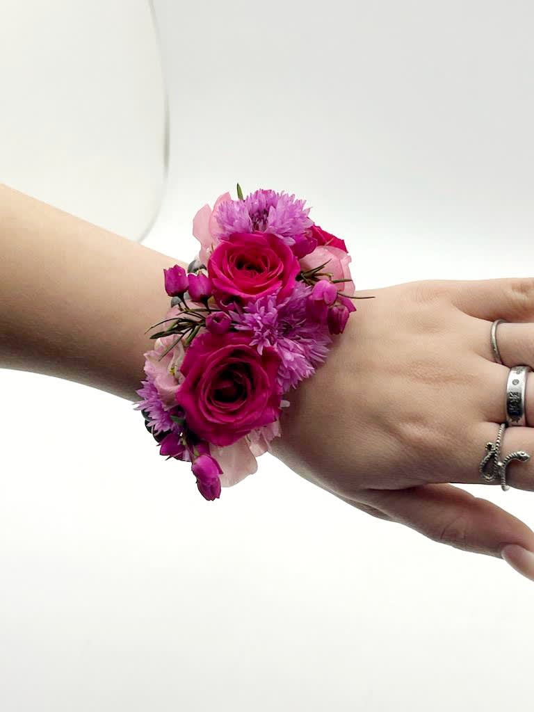 Hot Stuff Wrist Cuff Hot Stuff Wrist Cuff - A beautiful wrist cuff wrapped in hot pink flowers including larkspur, cornflower, boronia and spray roses.