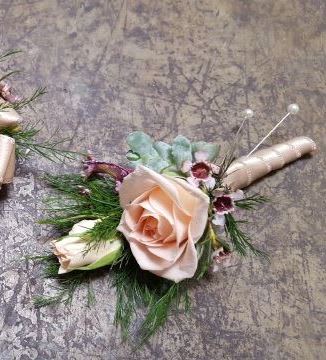 Ooo-La-La Boutonniere Ooo-La-La Boutonniere - Select this boutonniere with pale spray roses with a ivory stem wrap. ALL PROM FLOWERS ARE AVAILABLE IN COLORS PICTURED OR A CUSTOM SELECTION. CHOOSE YOUR FLOWER COLORS, RIBBON COLOR AND ANY ADD ONS. FOR QUESTIONS CALL A FRIENDLY SALES REPRESENTATIVE AT STRELITZIA FLOWER CO.