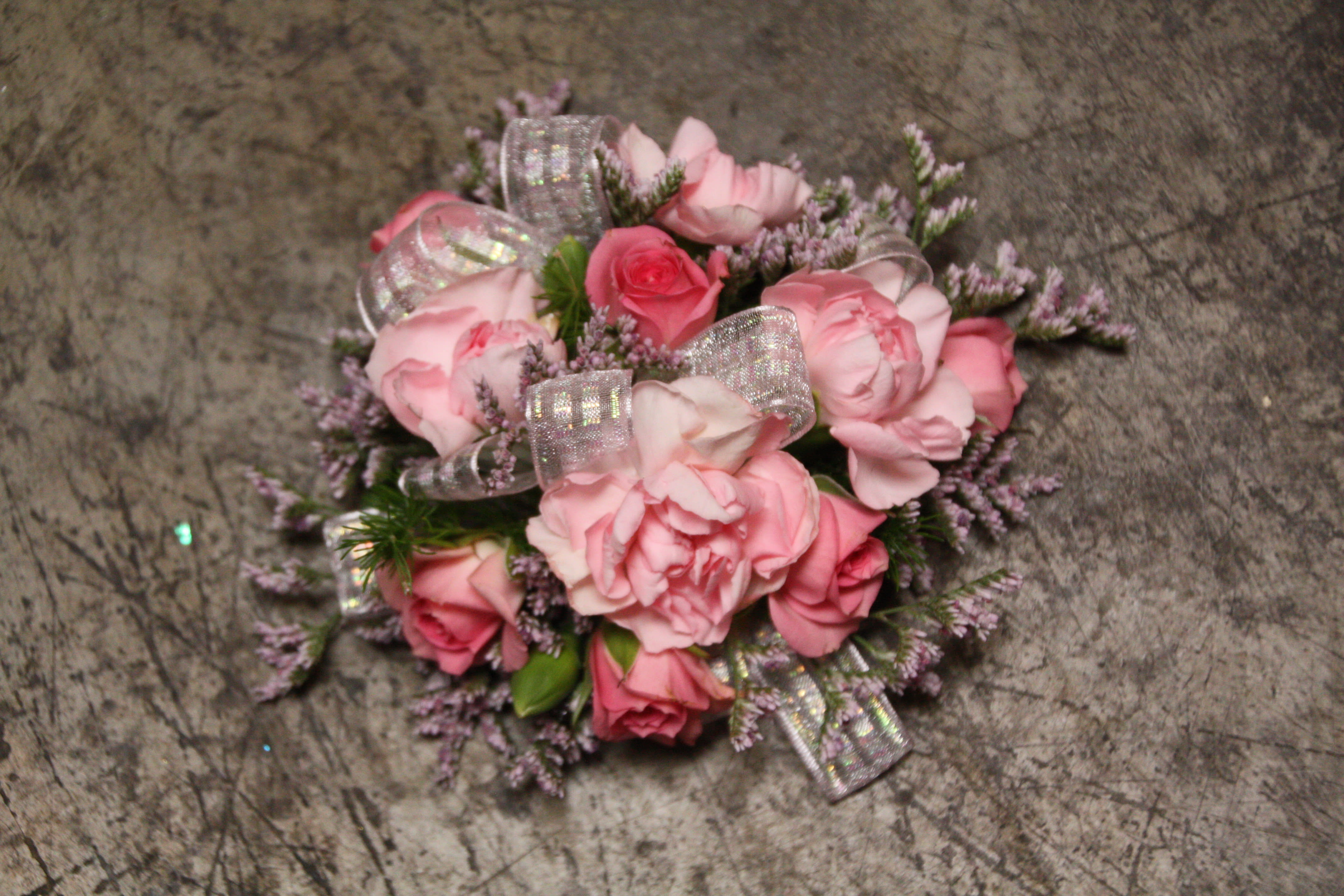 Sixteen Candles Wristlet Sixteen Candles Wristlet - Select this corsage of pink mini carnations and pink spray roses. ALL PROM FLOWERS ARE AVAILABLE IN COLORS PICTURED OR A CUSTOM SELECTION. CHOOSE YOUR FLOWER COLORS, RIBBON COLOR AND ANY ADD ONS. FOR QUESTIONS CALL A FRIENDLY SALES REPRESENTATIVE AT STRELITZIA FLOWER CO.