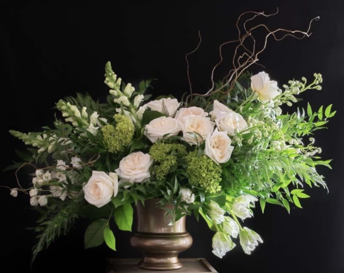 La Louve La Louve - Elegant and sophisticated, this arrangement is for the modern at heart. Designed with a lush mix of seasonal greenery and a stunning selection of seasonal white blooms, it will absolutely surprise and delight your loved one.