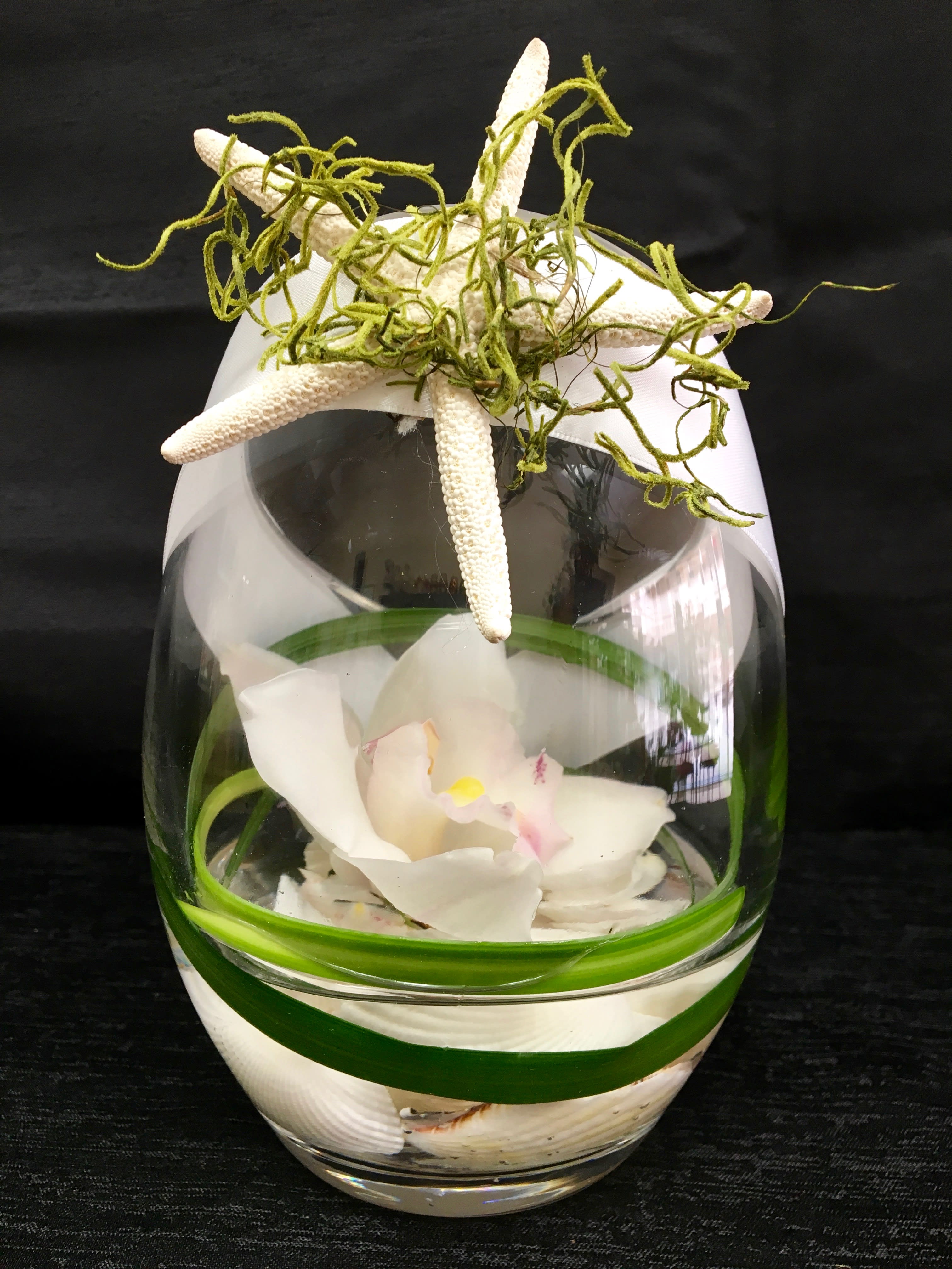 Sandy Beach - This arrangement is perfect heavy glass angle cut decorated with a beach motif with rubidium floating over shells. If you want to just brighten someone's day, this is perfect! 