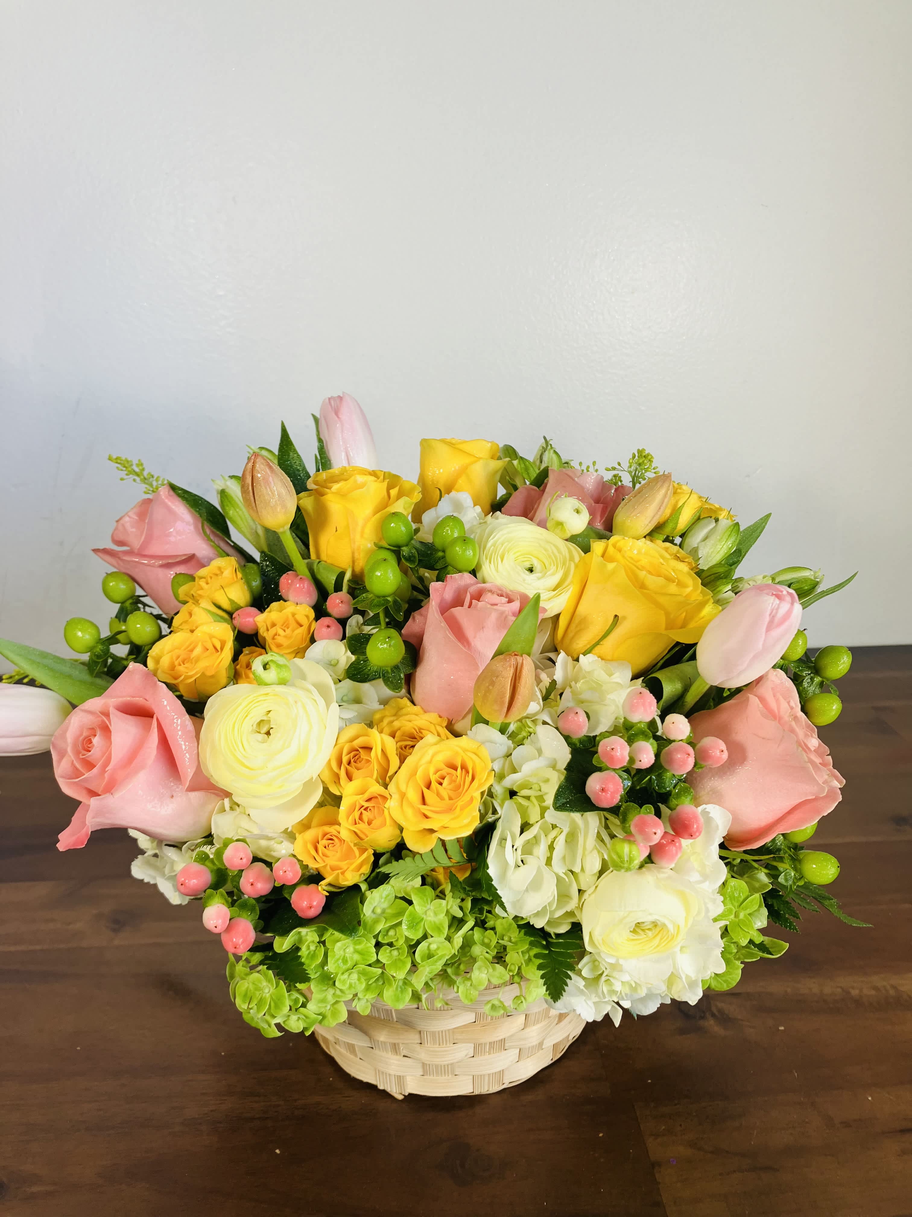 Spring time - Show your love with this  Basket filled with appreciation and elegance, an arrangement that is rich with high-end flowers, European Tulips, Chrysanthemum, Red Coffee Beans, Spray Roses  