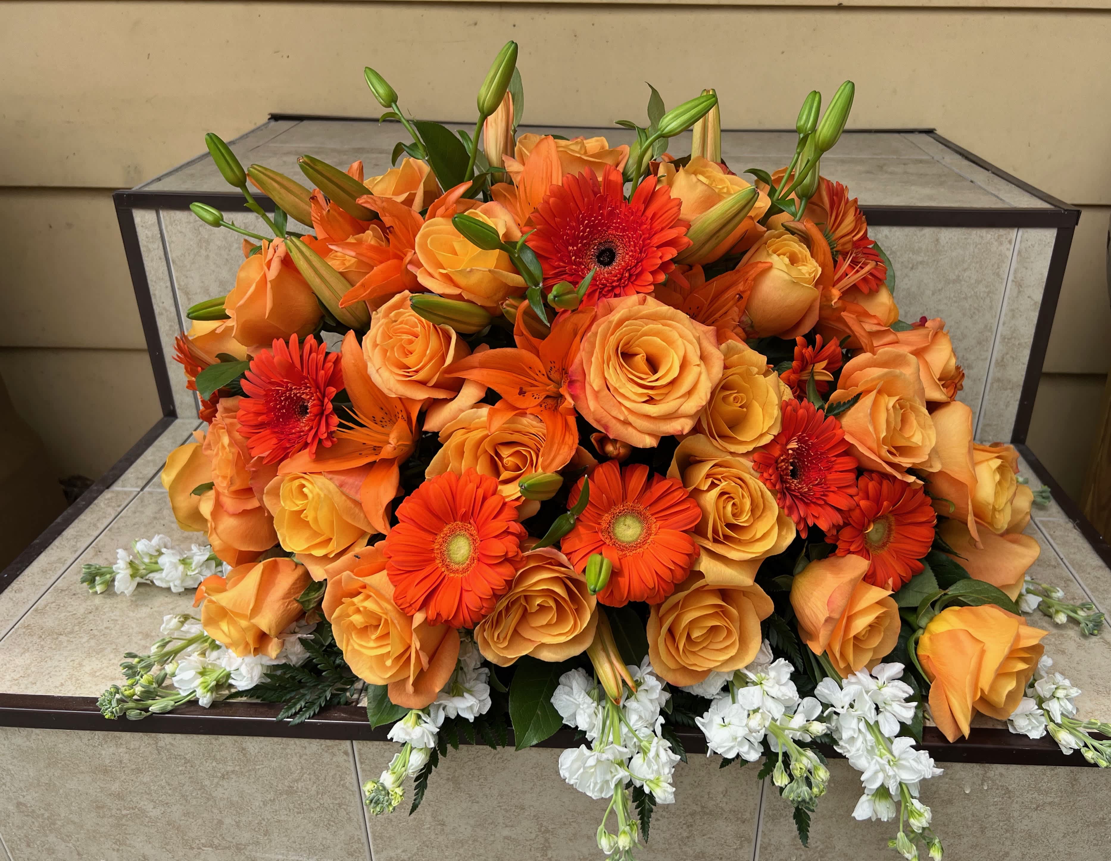 Orange Casket Spray - Orange roses, lilies and gerber daisies casket spray 
