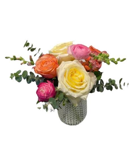 Summer Fling  - A sweet and petite arrangement in our pebble vase. Featuring Candlelight and Kahala roses, mini green hydrangea, snapdragons &amp; ranunculus with other accents.