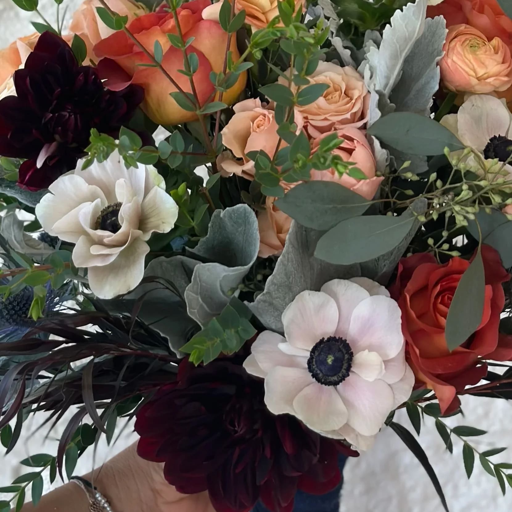 Moody Luxe Bouquet Moody Luxe Bouquet - The "Moody Luxe Bouquet" has burgundy, mustard, and rust accents. *Pictures are a representation of color pallets. The flowers in the photo may change based on availability.