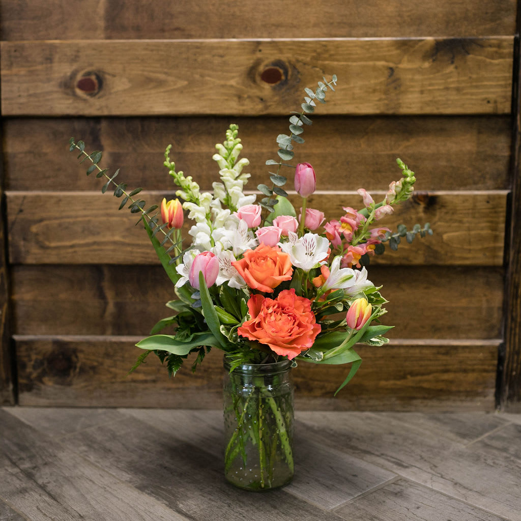 Cherished - Think spring, but with an elegant twist. Pink tulips, white and orange snapdragons and orange roses, all elegantly arranged in a simple hobnail glass vase.     Approximate Dimensions: 24&quot;H x 18&quot;W