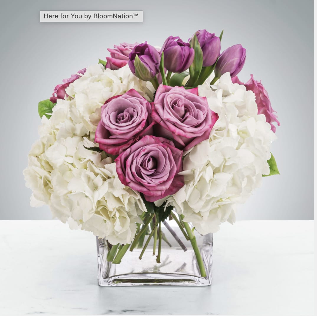 Here for You by BloomNation™ - Express your condolences after the loss of a loved one with flowers. Sending this clean purple and white arrangement featuring lavender roses and white hydrangea is a way to show you care and are thinking of them.  Approximate Dimensions: 11&quot;D x 11&quot;H