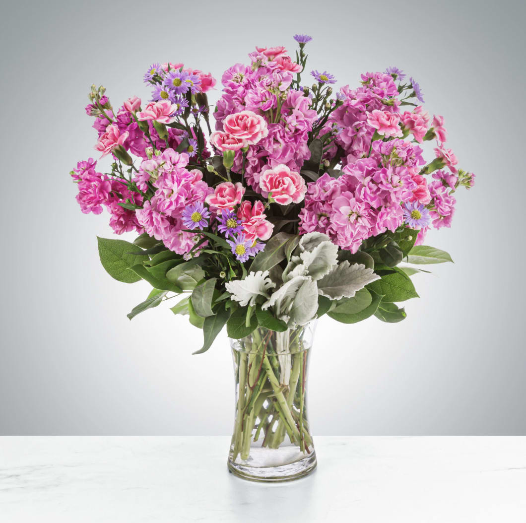Uptown Girl by BloomNation™ - This arrangement is a pink and purple confection featuring sweet-smelling stock flowers and purple asters. A great gift for birthdays, women's day, or breast cancer awareness month.  Approximate Dimensions: 12&quot;D x 17&quot;H