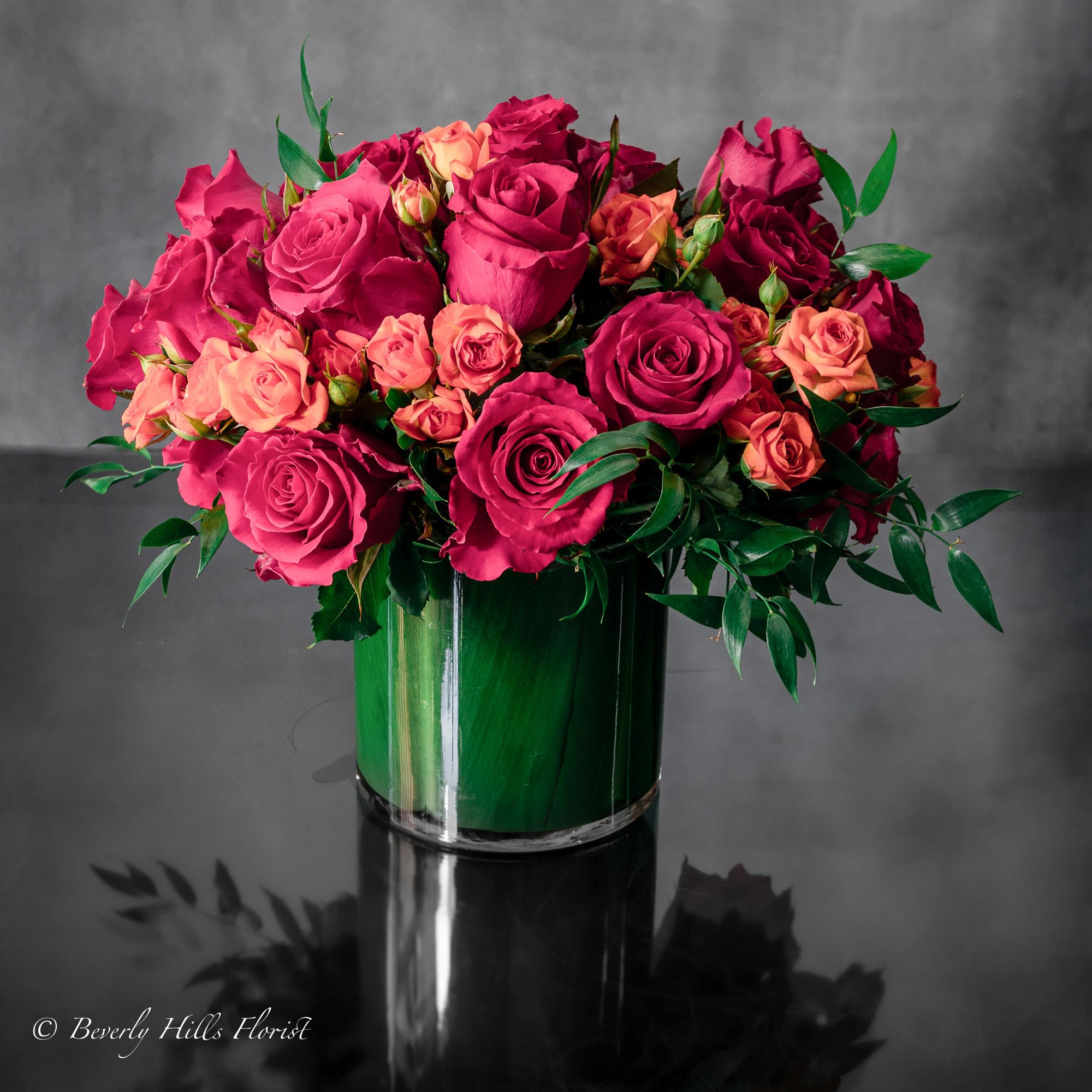 Summer Roses - Sherman Oaks Florist Summer Roses - Sherman Oaks Florist - Beverly Hills Florist presents our Summer roses for same day delivery! This lavish array of Hot pink Roses and vibrant orange spray Roses. Send this glamorous display of blooms to dazzle your loved one. Some of the blooms may vary depending on the season. Deluxe as Shown Standard 6x6 inch base (Deluxe pictured)
