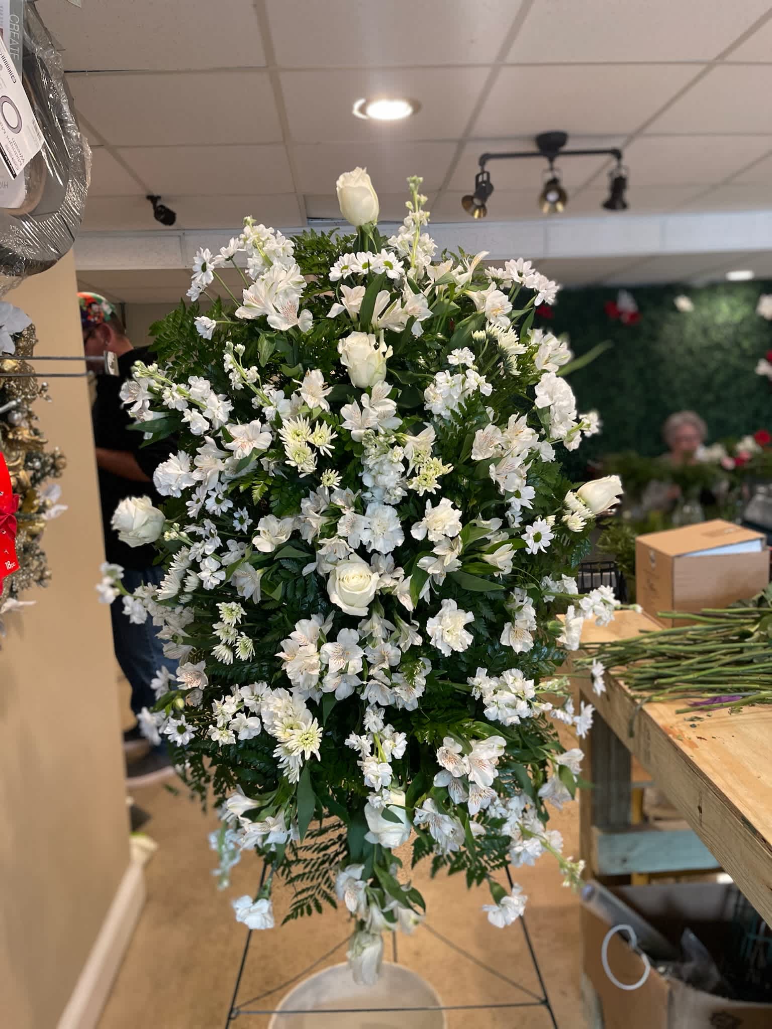 True Sympathy  - An all-white tribute, this funeral spray is pure and tranquil. A variety of white flowers and greens this elegant funeral spray brings a feeling of peace to it's surroundings 