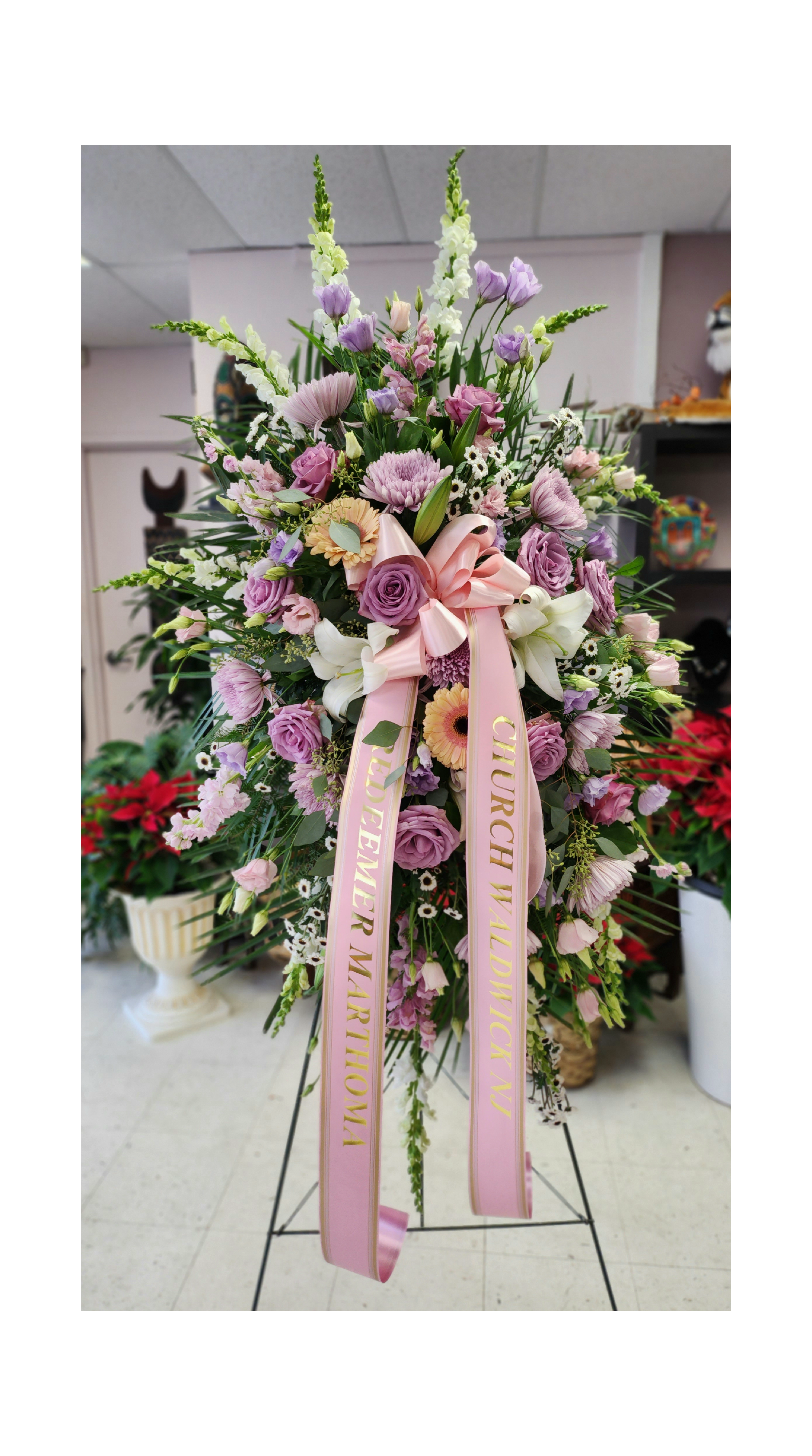 Lavender tribute spray  - Utterly feminine, this spray is an extraordinarily beautiful way to bid farewell to someone who will remain forever in your heart. A bevy of lovely lavender flowers will soothe souls and deliver strength and hope to those in mourning.