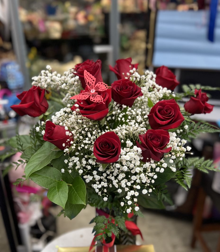 One dozen roses in a vase  - Red Roses and babies breath in a clear vase . Let me know in the notes section if you would like different colors on the roses 