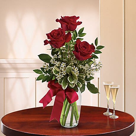 Sweet Trio  - This gorgeous trio of red roses accented with lush greenery in a sparkling vase is so surprisingly affordable that you may want to send it to several special people. A sweet, simple expression of your love. Send to the office early and make them blush!