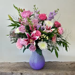 Mom's the Best! - A Large Lavender dimpled vase with Star Gazer Lillie's,  Stock, Roses, Gerber Daisey, Peonies, Cremona mums, Limonium, Hypericum Berry and Bay leaves Colors are subject to change slightly.