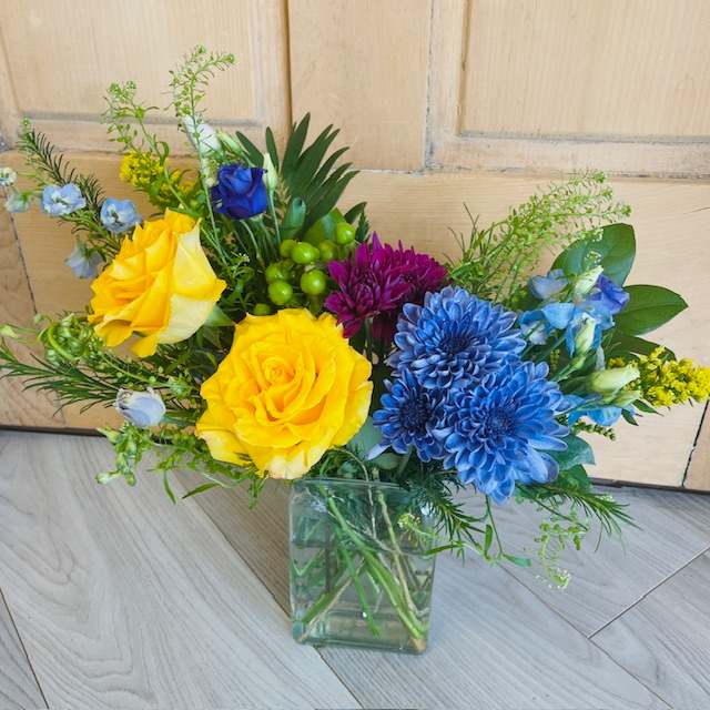 Bright and Cheerful Arrangement - A selection of bright and cheerful flowers arranged in a vase or container. Photos are samples only. Flower selection and container will vary based on availability. 